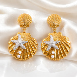 Gold shell starfish earrings styled in a beach-inspired jewellery flat lay