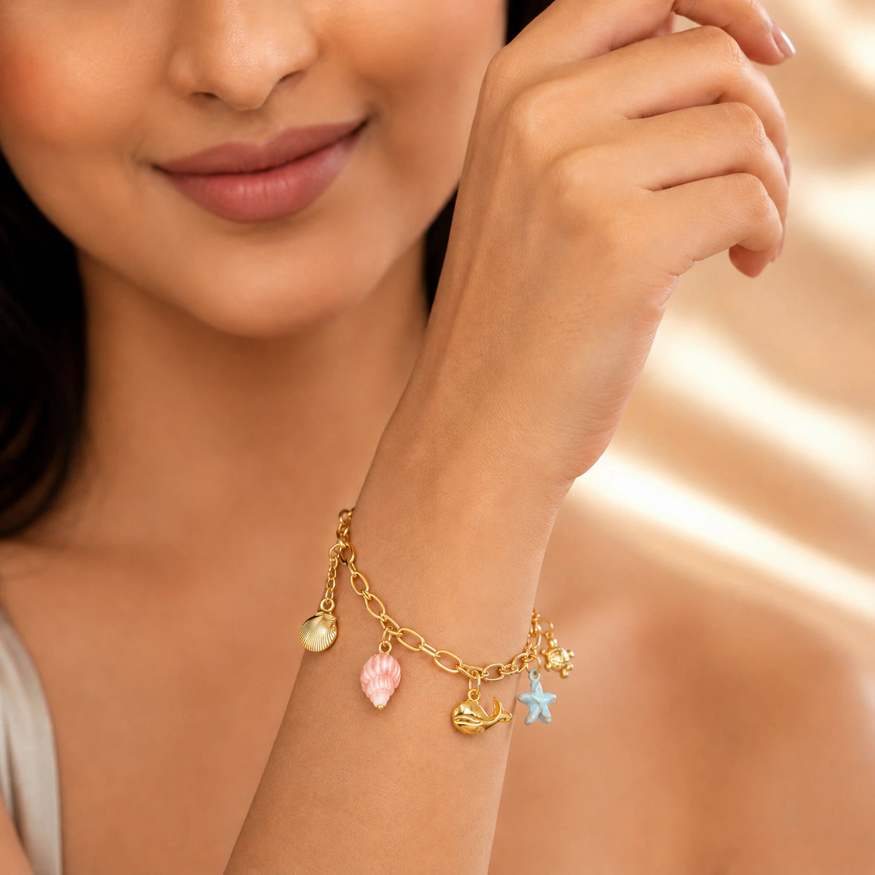 Angled view of the gold shell turtle starfish bracelet