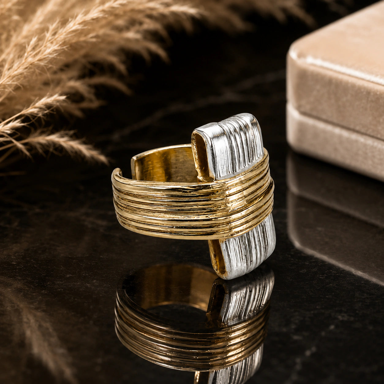 Gold and silver geometric ring styled in an elegant jewellery flat lay