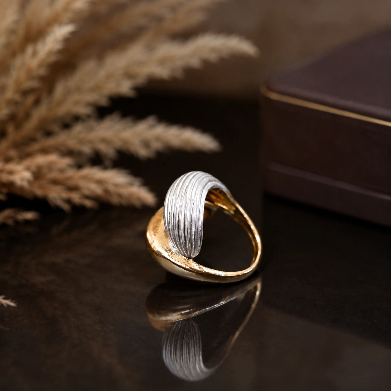 Gold and silver wrap ring styled in an elegant jewellery flat lay