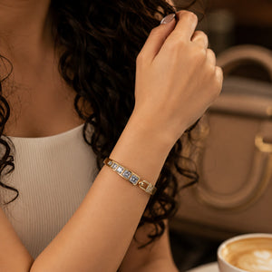 Angled view of the gold square crystal-bar hinged kada