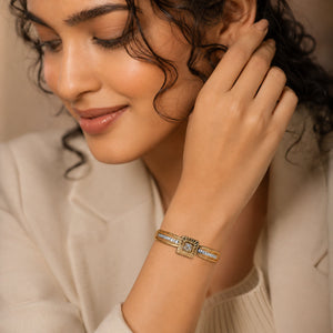 Gold square sunburst crystal bracelet on a dark jewellery studio display