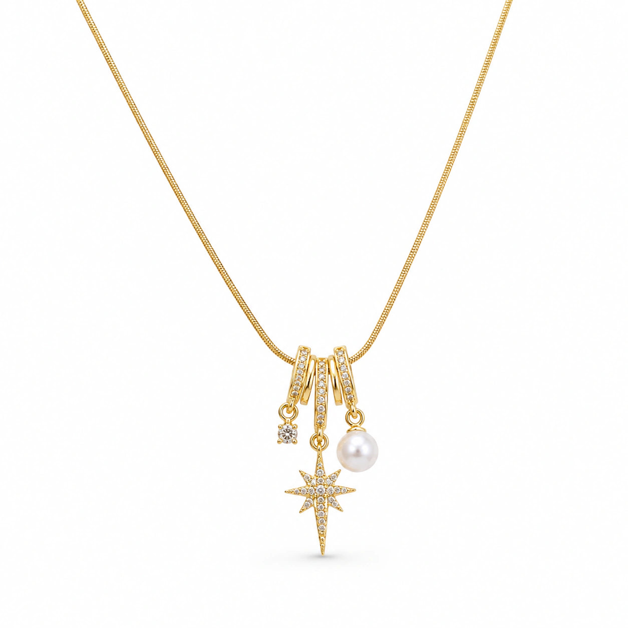 Angled view of the gold starburst pearl charm necklace