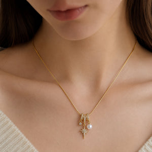 Close-up of the celestial starbursts and pearl-style charm detailing