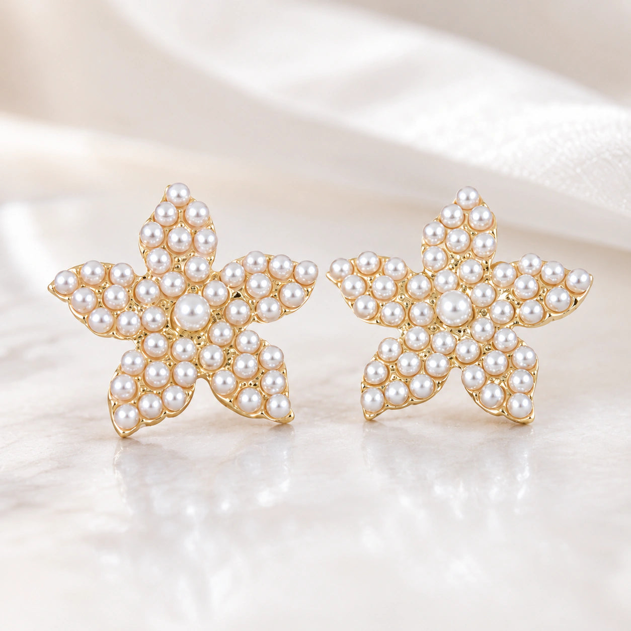 Product details card for gold starfish pearl stud earrings