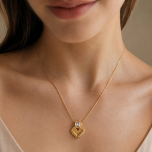 Close-up of the oval crystal and sunburst pendant detailing