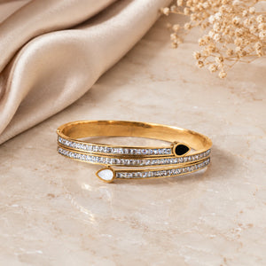 Close-up of teardrop crystals and layered kada detailing