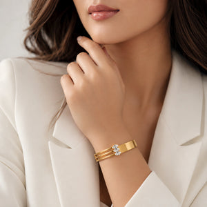 Gold triple-bar crystal kada on a dark jewellery studio display