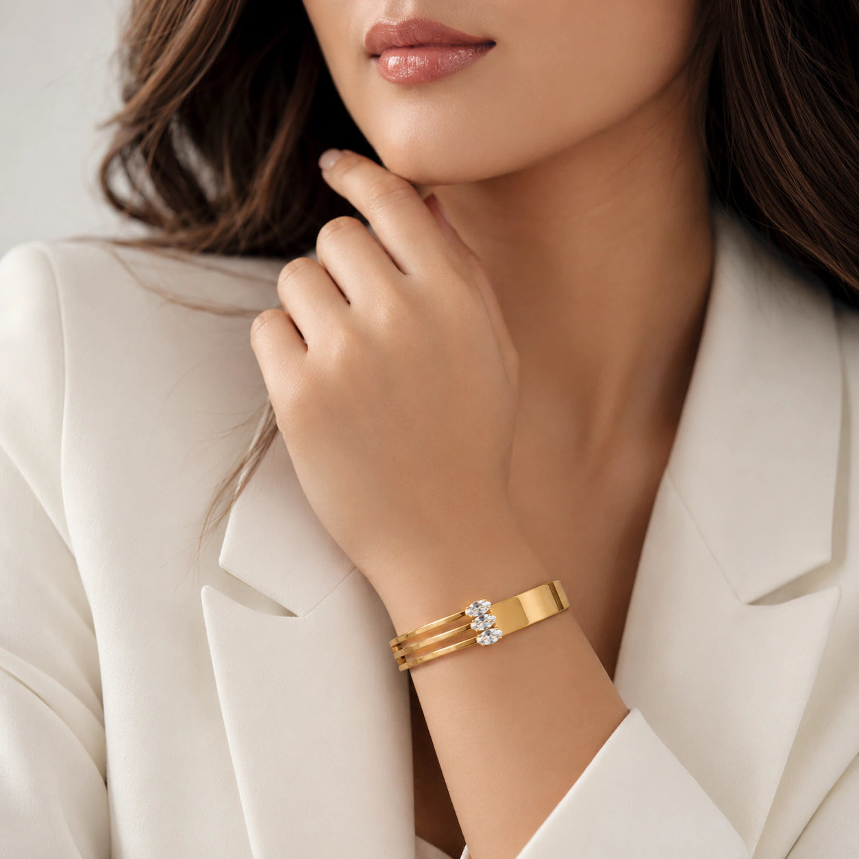 Gold triple-bar crystal kada on a dark jewellery studio display
