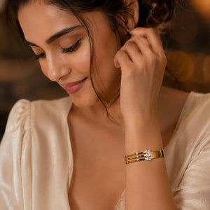 Side view of the gold triple-bar crystal kada