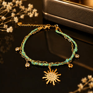 Gold turquoise sunburst bracelet styled in an elegant jewellery flat lay