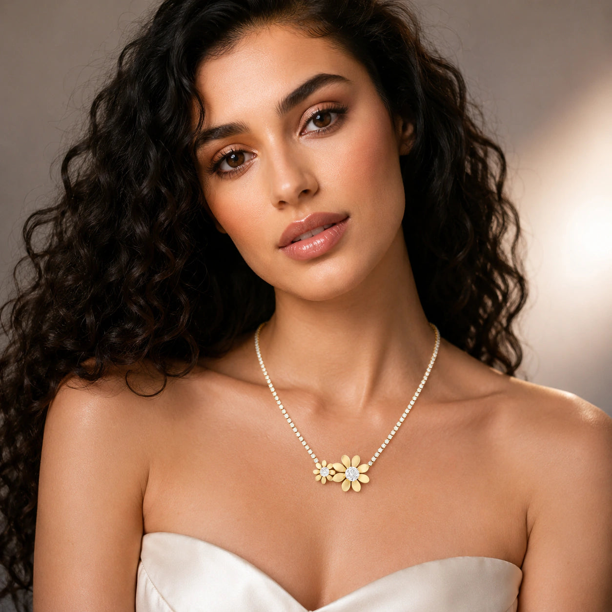Gold twin floral crystal necklace on a dark jewellery studio display