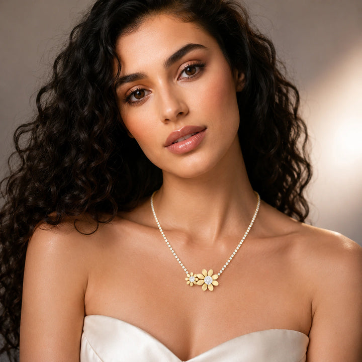 Gold twin floral crystal necklace on a dark jewellery studio display