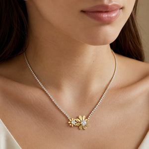 Gold twin floral necklace styled in an elegant jewellery flat lay