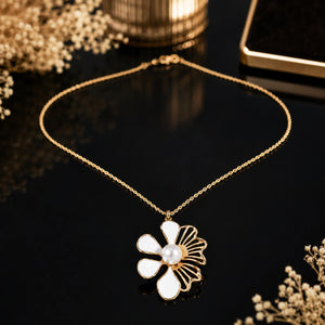 Close-up of the white floral and pearl-style pendant detailing