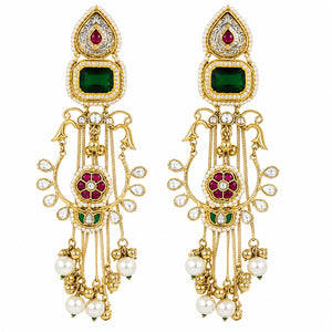 Angled view of long green-stone Kundan-style earrings with layered hanging details