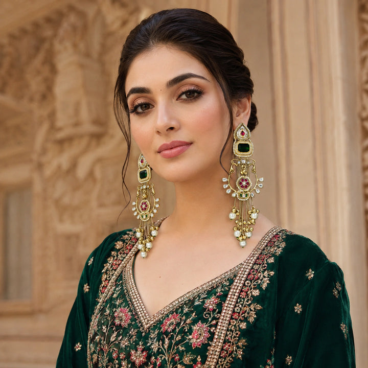 Close-up of green stones, Kundan-style settings and layered gold-tone statement detailing