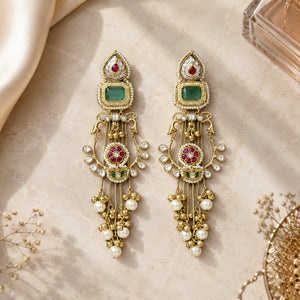 Green-stone pearl chandelier earrings styled in an elegant jewellery flat lay