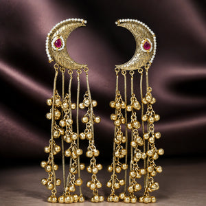 Gold-tone Kundan-style chandbali earrings styled in an elegant jewellery flat lay