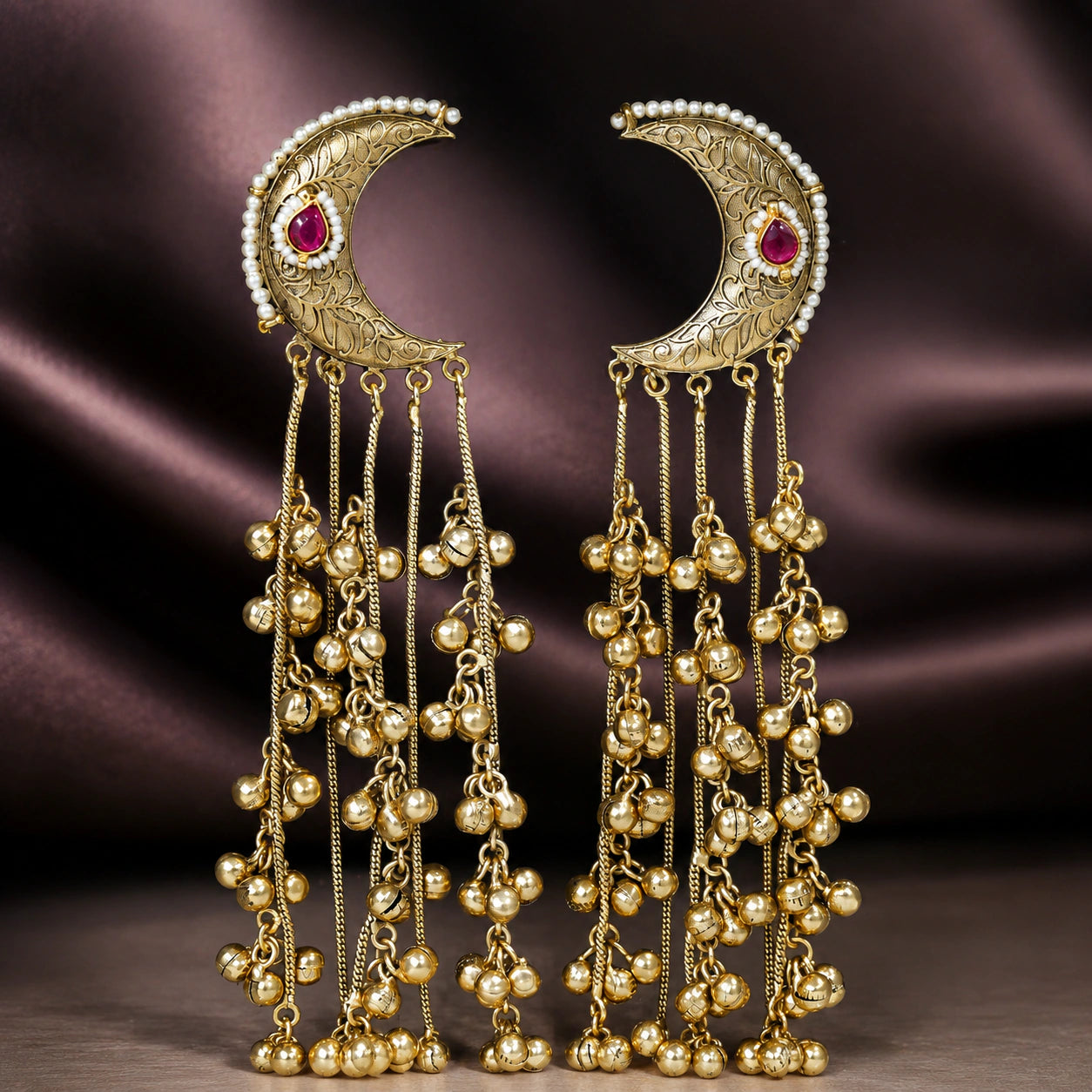 Gold-tone Kundan-style chandbali earrings styled in an elegant jewellery flat lay