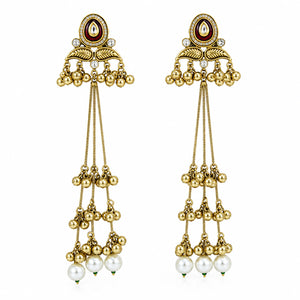 Gold-tone Kundan pearl chandelier earrings styled in an elegant jewellery flat lay