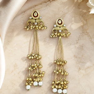 Gold-tone Kundan pearl chandelier statement earrings worn by a model