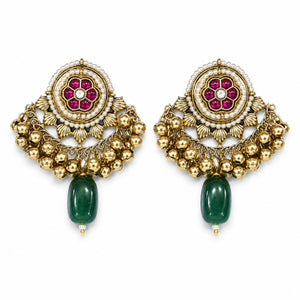 Gold-tone Kundan pearl jhumka earrings worn by a model
