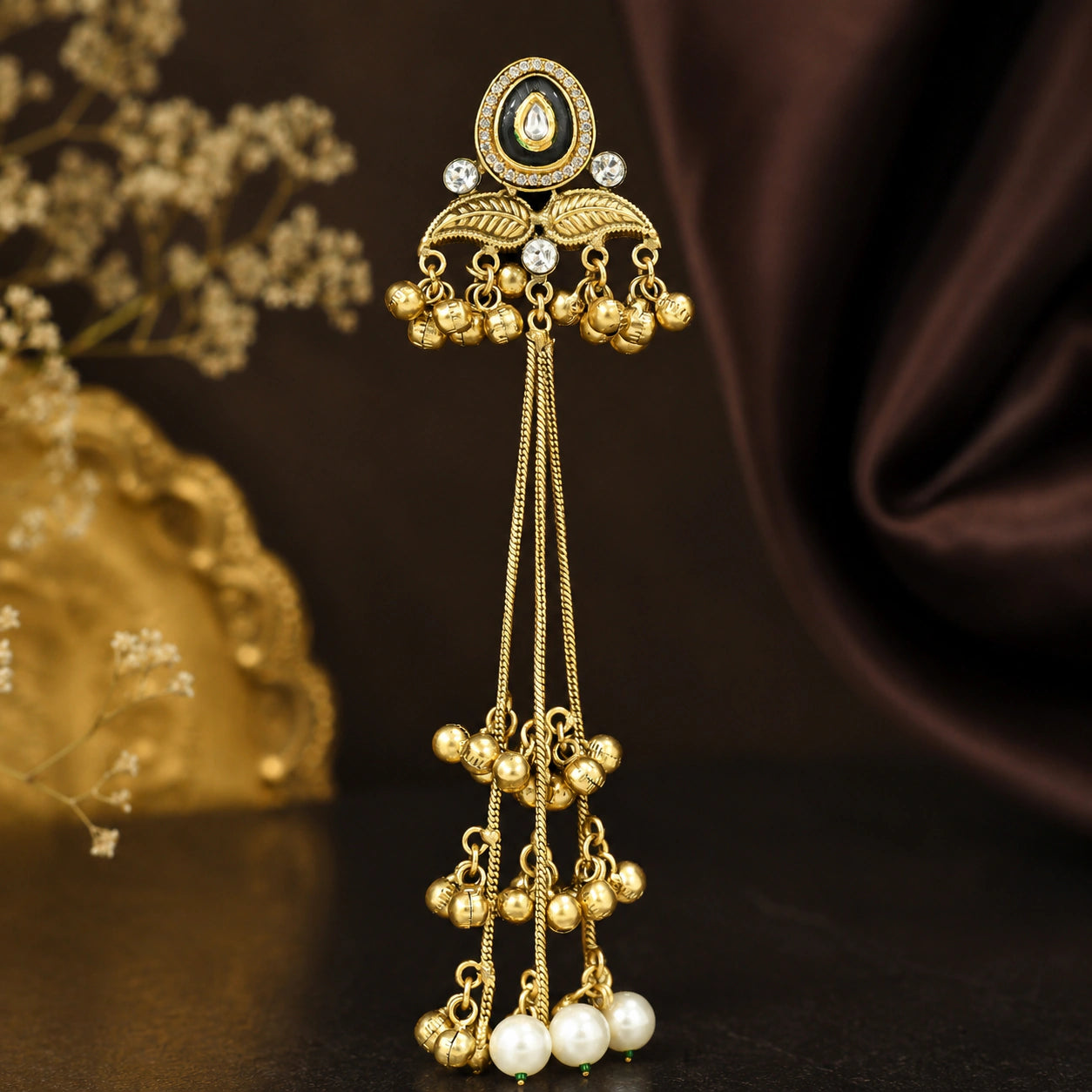 Close-up ear view showing the layered pearl-style tassel drops