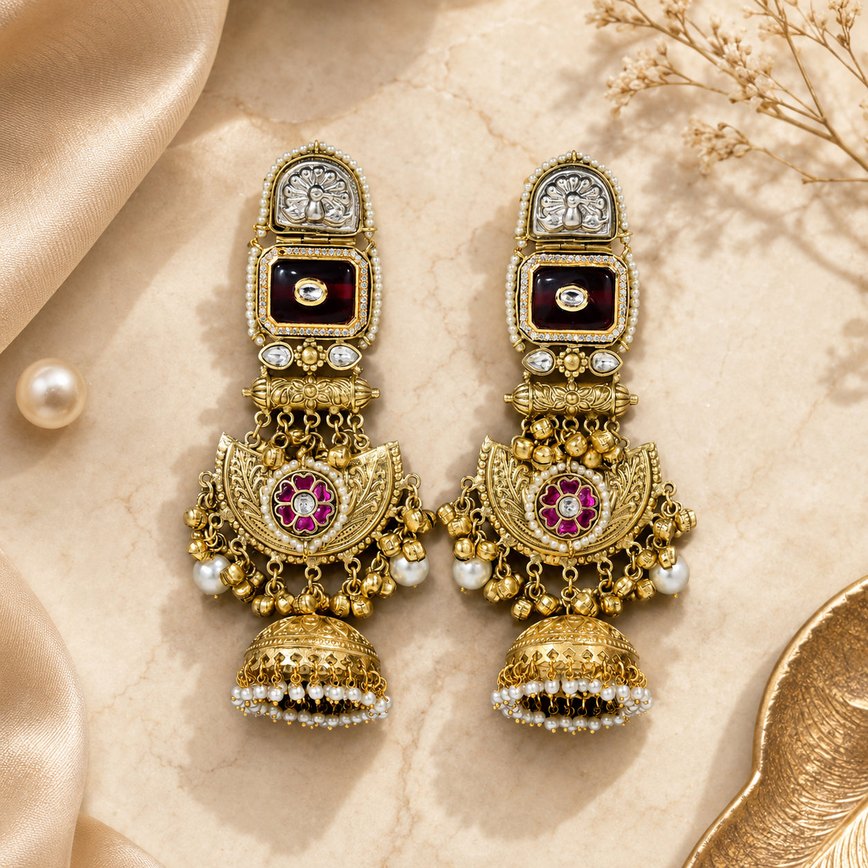 Close-up ear view showing the statement length of maroon chandbali earrings