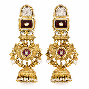 Maroon-stone chandbali earrings styled in an elegant jewellery flat lay