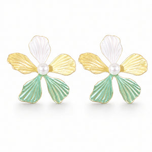 Multicolour floral pearl earrings styled in a modern jewellery flat lay