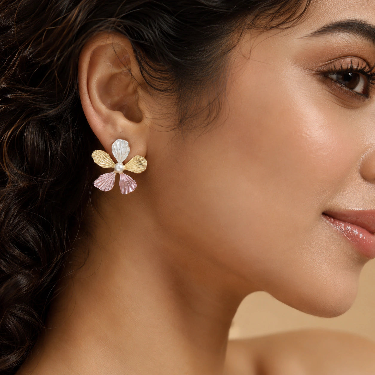 Pink floral pearl earrings styled in a modern jewellery flat lay