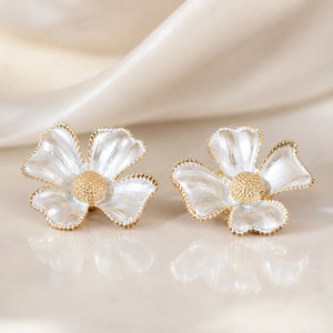 Pearl gold floral earrings styled in a modern jewellery flat lay