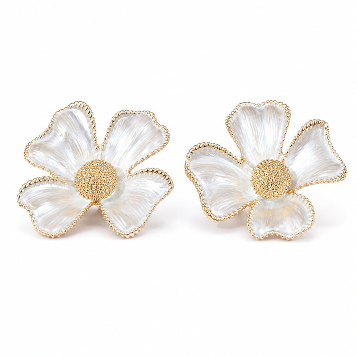 Close-up of sculpted gold flowers and pearl-style drops