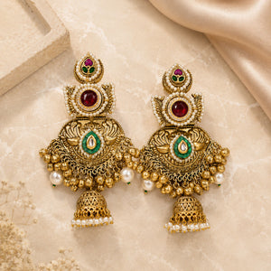 Angled view of gold-tone pearl Kundan-style statement jhumka earrings