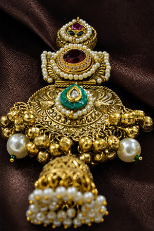 Gold-tone pearl Kundan-style statement jhumka earrings worn by a model