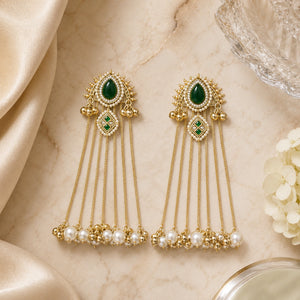 Gold-tone pearl tassel statement earrings styled in an elegant jewellery flat lay