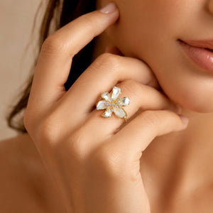 Angled view of the pearl-white crystal floral ring
