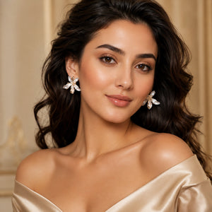 Side view of pearl-white leaf floral gold-tone drop earrings