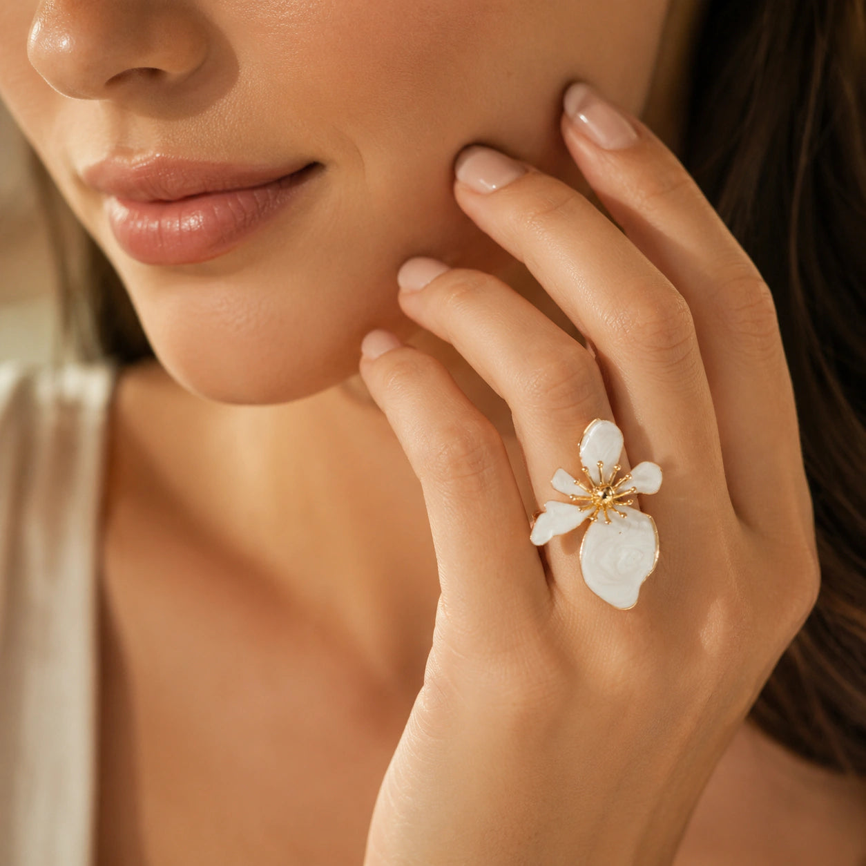 Pearl-white marbled petal ring on a dark jewellery studio display