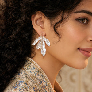 Close-up of pearl-white sculptural leaves and gold-tone edging