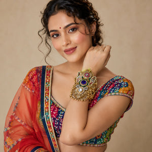 Purple Kundan pearl handwork kada on a dark jewellery studio display