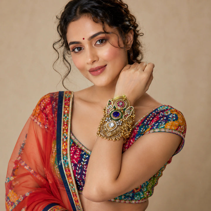 Purple Kundan pearl handwork kada on a dark jewellery studio display