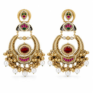 Angled view of red-stone chandbali earrings with pearl-style hanging details