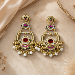Close-up ear view showing the statement profile of red-stone pearl chandbali earrings