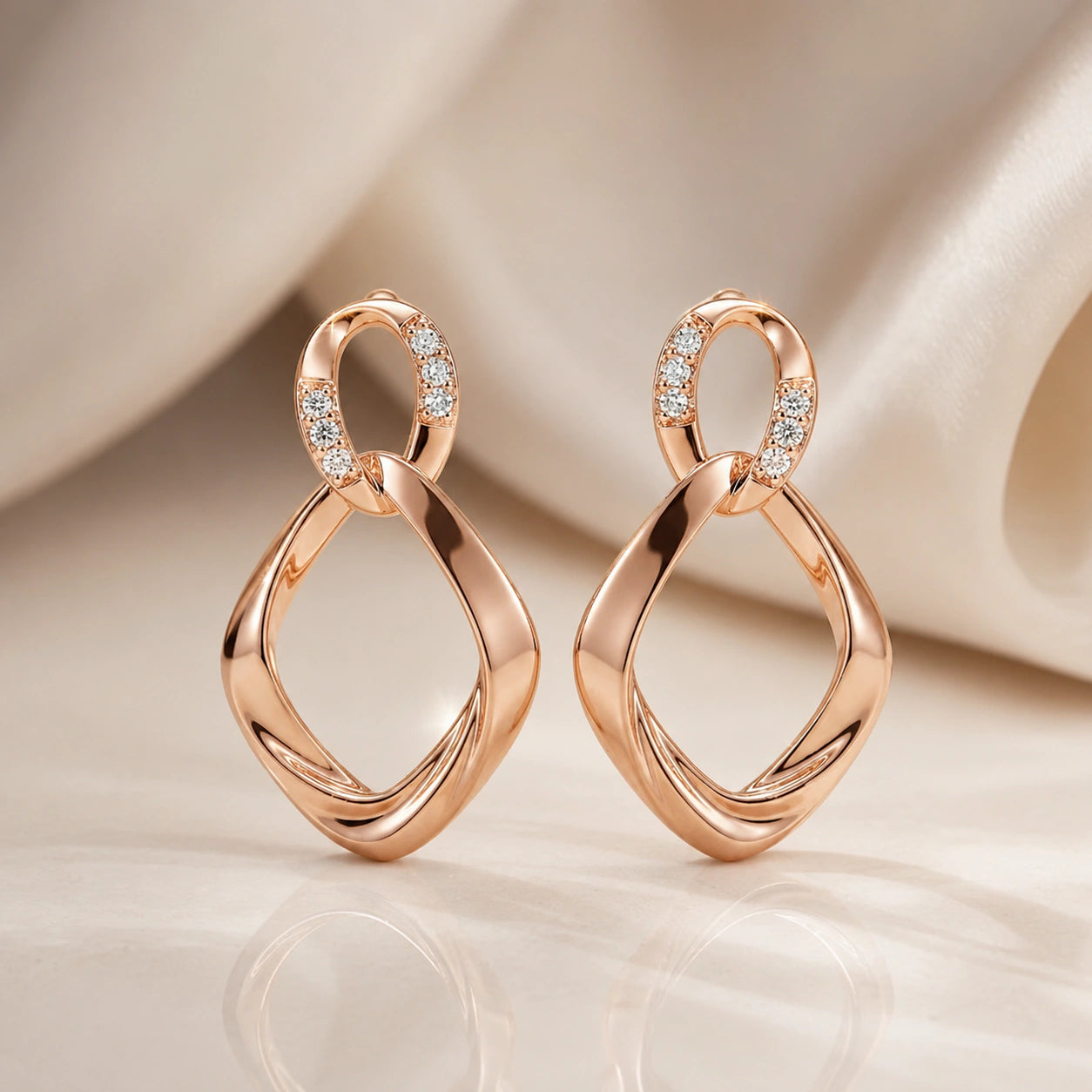 Rose-gold crystal teardrop earrings styled in an elegant jewellery flat lay