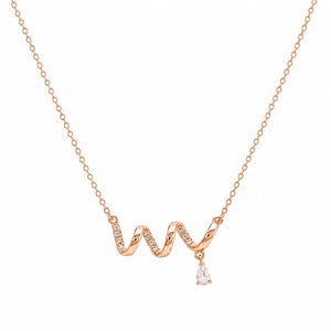 Angled view of the rose-gold crystal wave drop necklace