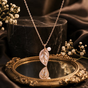 Alternate detail view of the rose-gold pearl leaf pendant
