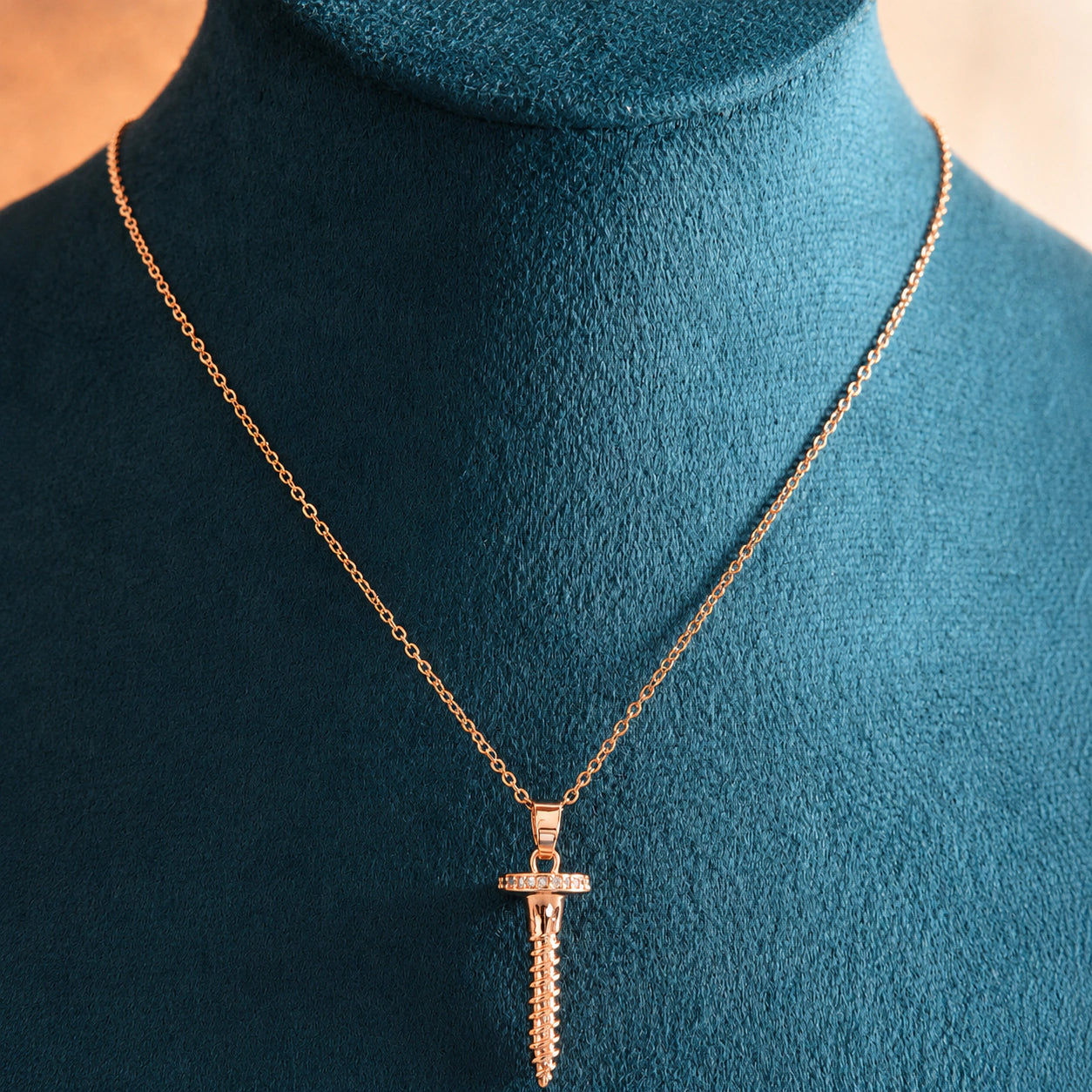 Alternate detail view of the rose-gold screw charm pendant