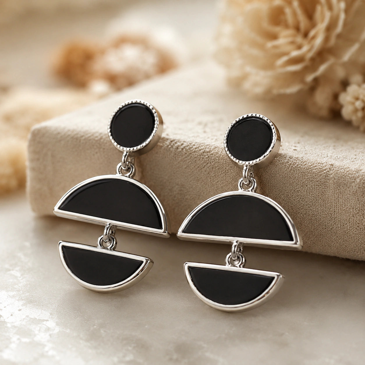 Silver black floral pearl hoops styled in a modern jewellery flat lay